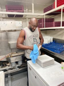 Omar washing dishes